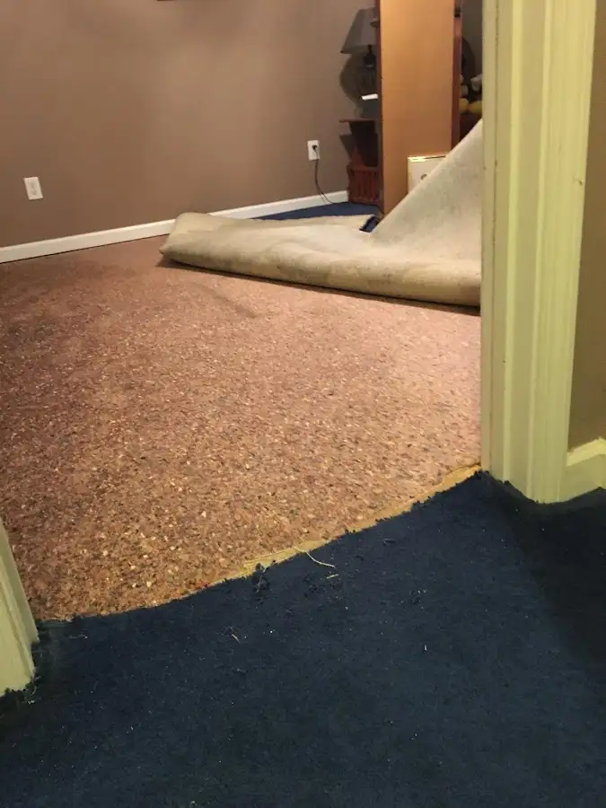 Carpet pad removal revealing water damage during Drying & Dehumidification in Victorville